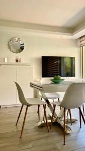 a dining room with a table and two chairs at Charmant appartement plein centre in Saint-Tropez