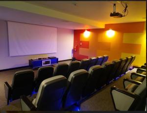 a conference room with chairs and a white screen at DJamez in Quito +7 photos