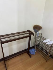 a room with a broom next to a wall at Ally home 14 06 in Thung Si Kan +6 photos