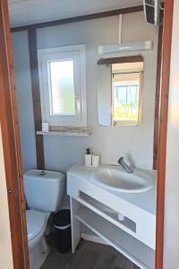 a bathroom with a sink and a toilet at Chalet Lot 23 - 4-6 places in Herm