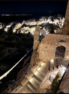 a set of stairs leading up to a building at night at Very Peri Cappadocia - The Lifestyle Luxury Design Hotel in Uchisar