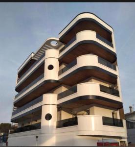 a tall white building with a lot of windows at Essenza INN Luxury Apartaments in Pescara