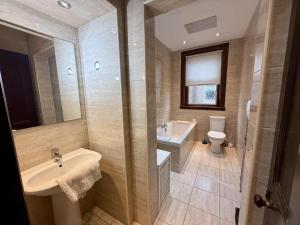 a bathroom with a sink and a toilet at The Orchard Hotel in Falkirk +36 photos