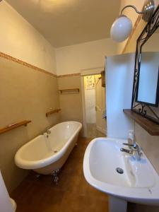 a bathroom with a white tub and a sink at CASA VACANZA Dimora del tempo in Fara San Martino +56 photos