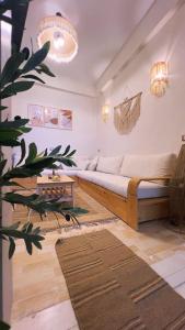 a living room with a couch and a plant at Shali Home in Siwa