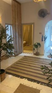 a room with a hallway with a door with a rug at Shali Home in Siwa