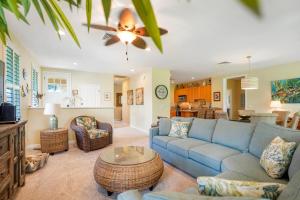 a living room with a blue couch and a table at Nihilani 21C in Princeville