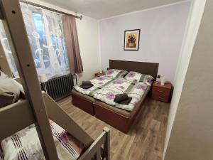 a small bedroom with a bed and a window at RD ve Vilémovicích U Macochy v Moravském krasu in Jedovnice