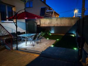 a patio with a table and chairs with lights at RD ve Vilémovicích U Macochy v Moravském krasu in Jedovnice
