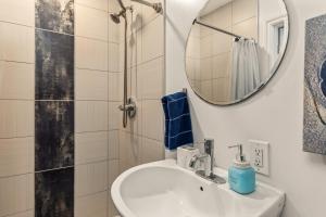 a bathroom with a sink and a mirror and a shower at Beach Front Bungalow At Pacific Beach in San Diego +36 photos