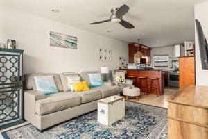 a living room with a couch and a kitchen at Beach Front Bungalow At Pacific Beach in San Diego