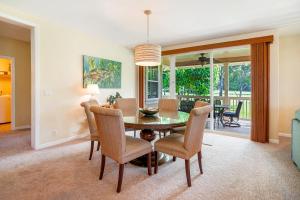 a dining room with a table and chairs at Nihilani 21C in Princeville