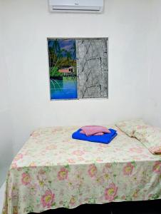 a bed with a blanket on it with a window at Apartamento Completo e Centralizado 3 in Belém