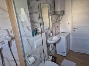 a bathroom with a toilet and a sink at Apartman Malomi in Solin +3 photos