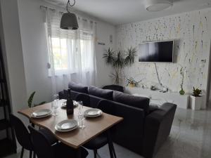 a living room with a table and a couch at Apartman Malomi in Solin