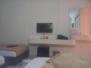 Ένα ή περισσότερα κρεβάτια σε δωμάτιο στο pound daily