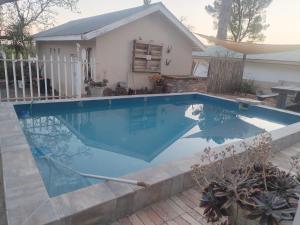 a swimming pool in front of a house at Uitzight - Pool unit in Beaufort West