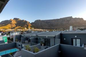 an apartment building with a mountain in the background at Emerald Escape With Mountain View & Pool in Cape Town