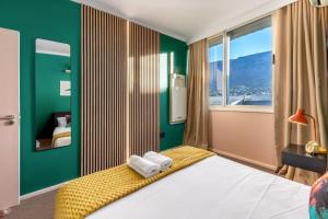 a bedroom with green walls and a bed with towels at Emerald Escape With Mountain View & Pool in Cape Town +28 photos