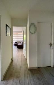 an empty living room with a couch and an open door at Charmant appartement plein centre in Saint-Tropez +4 photos