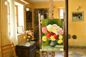 a painting of flowers in a vase on a table at Art Villa Bakuriani in Bakuriani