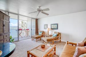 a living room with a couch and a table at Wailua Bay View 206 in Wailua
