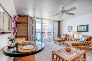 a living room with a table and a couch at Wailua Bay View 206 in Wailua
