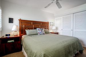 a bedroom with a bed and two lamps and a fan at Wailua Bay View 206 in Wailua +19 photos