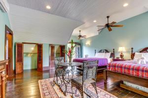 a bedroom with two beds and a table and chairs at Monkey Suite at Mahogany Hall -Gold Standard Certified in Bullet Tree Falls +23 photos