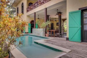 a house with a swimming pool and a patio at Monkey Suite at Mahogany Hall -Gold Standard Certified in Bullet Tree Falls