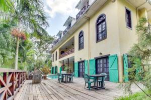 an exterior view of a house with a wooden deck at Monkey Suite at Mahogany Hall -Gold Standard Certified in Bullet Tree Falls