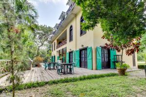 a wooden deck in front of a house with trees at Monkey Room at Mahogany Hall -Gold Standard Certified in Bullet Tree Falls