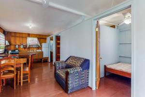 a living room with a couch and a table at Tarpon at Carol's Cabanas -Gold Standard Certified in Placencia Village +13 photos