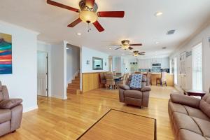 a living room with a ceiling fan and a couch at Ocean View 5BR l Steps to Beach l Pet-Friendly in Bolivar Peninsula