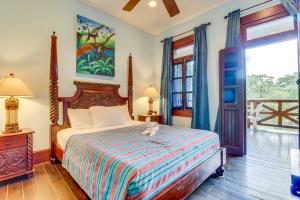 a bedroom with a bed with a stuffed animal sitting on it at Parrot Room at Mahogany Hall -Gold Standard Certified in Bullet Tree Falls