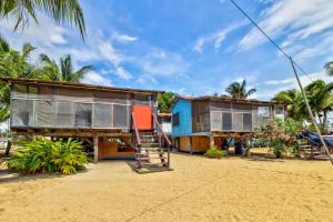 a group of houses on the beach at Bonefish at Carol's Cabanas -Gold Standard Certified in Placencia Village