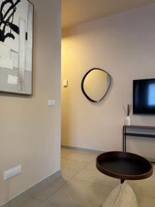 a room with a table and a mirror on the wall at L'Atelier - 2 min walk to Bernina Express in Tirano