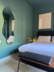 a bedroom with a bed and a mirror at L'Atelier - 2 min walk to Bernina Express in Tirano