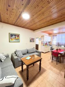 a living room with a couch and a table at Shkodra Guest House & Trips in Shkodër
