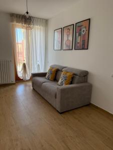 a living room with a couch in a room at Milan Penthouse - Humanitas - IEO - La casa di Martina in Pieve Emanuele