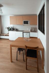 a kitchen with a wooden table in a room at Studio Cosy - Bas Montreuil in Montreuil