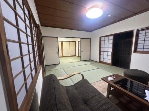 una sala de estar con un sofá y una mesa en Suzuya, en Hanabuchihama 30 fotos más