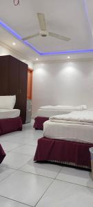 a room with two beds and a ceiling at نزل الاوئل in Al Madinah