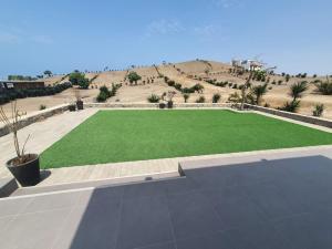 a large artificial lawn in the middle of a desert at CASA PLAYA con PISCINA in Punta Negra