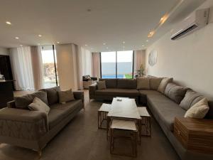 a living room with a couch and a table at عمان البحر الميت in Sowayma