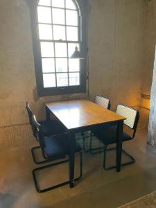 a wooden table and chairs in a room with a window at Cozy Double Queen Apartment Close to Fiserv with Parking in Milwaukee