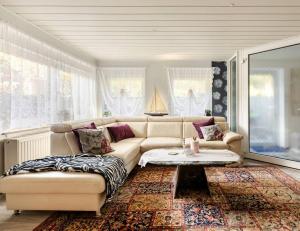 a living room with a couch and a coffee table at Große Helle Wohnung am Wald in Bad Saarow Nahe Grünheide und Berlin Souterrain in Bad Saarow