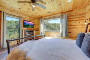 Un dormitorio con una cama y un televisor y ventanas. en Game Room, Hot Tub, Pool and Views Gatlinburg Cabin, en Gatlinburg 33 fotos más