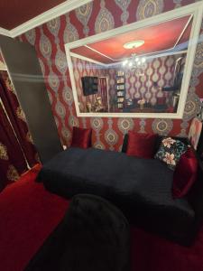 a bedroom with a bed in a room with red walls at JEVA Apartman in Hajdúszoboszló