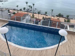 an overhead view of a swimming pool next to a beach at Porto Marina in Salvador